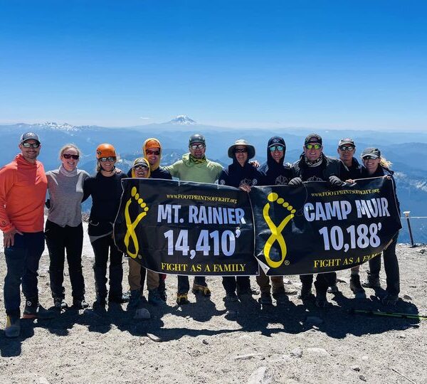 Climbers holding up a sign from the Climb for a Cause challenge